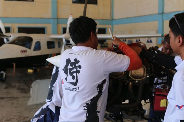 AAA maintenance team inspecting aircraft engine at Iba Airport hangar