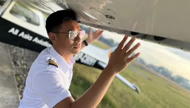 AAA Academy pilot inspecting a training aircraft before flight