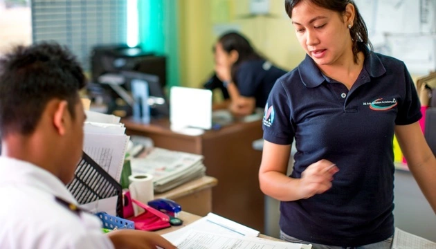 AAA Academy staff assisting a student with training and administrative support