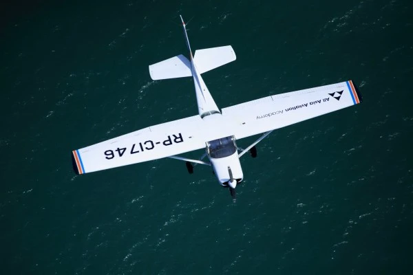 Top-down aerial view of AAA's Cessna 152 in flight