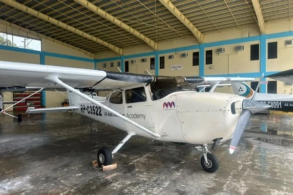 AAA Cessna 172S training aircraft parked inside the academy hangar